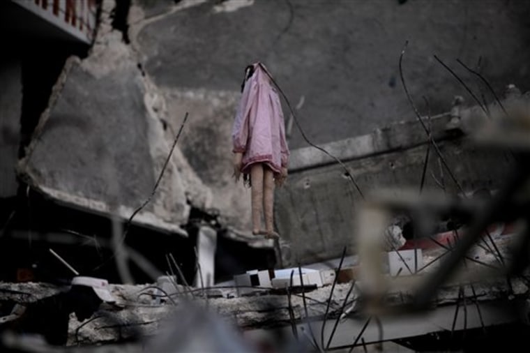 A rag doll hangs from the remains of a  destroyed house in Port-au-Prince, Tuesday, Feb. 9, 2010. A powerful earthquake hit Haiti on Jan. 12. (AP Photo/Ramon Espinosa)